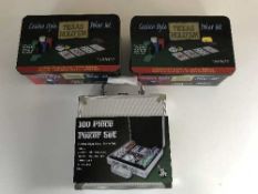 A box of three cased poker sets,