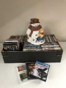 A box of assorted DVDs and a Disney cookie jar
