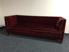 An Edwardian mahogany framed settee upholstered in red dralon