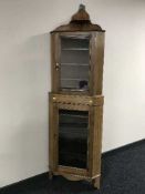 An Edwardian glazed door corner cabinet
