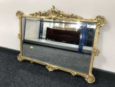 A late 19th century decorative framed overmantel mirror
