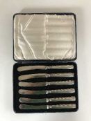 A set of six cased silver handled knives,