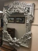 A highly ornate silvered mirror