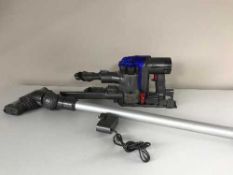 A Dyson DC35 multifloor hand held vac with attachments