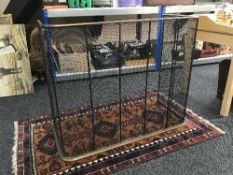 An antique brass framed spark guard