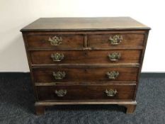 An early 19th century mahogany five drawer chest on bracket feet