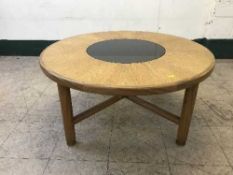 A teak and glass circular coffee table