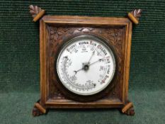 A carved oak barometer