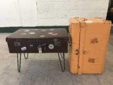 A vintage leather suitcase and a painted tin trunk