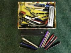 A box of assorted fountain pens and writing utensils
