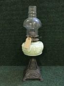 An oil lamp on cast metal base