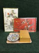A tray of two oriental wall plates, Chinese ornament on stand,