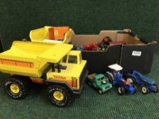 A box of two Tonka trucks and other die cast vehicles