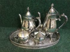 A plated four piece tea service on gallery tray