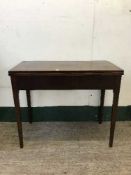 A 19th century mahogany turnover tea table