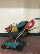 A Bosch lawn mower, wheel barrow, garden strimmer, tools, hose,