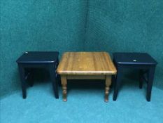 A pine occasional table and a pair of painted stools