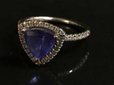 A 14ct white gold diamond and tanzanite ring,