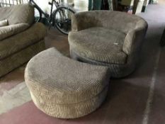 A contemporary horseshoe shaped chair and footstool