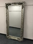 An ornate silvered mirror,