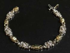 An 18ct yellow and white gold diamond set bracelet 18 grams, .