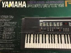 A boxed Yamaha PSR-200 keyboard and two golf drivers
