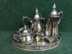 A plated four piece tea service on gallery tray and two similar sifters