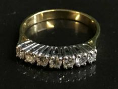 An 18ct gold seven stone diamond ring, approx 0.