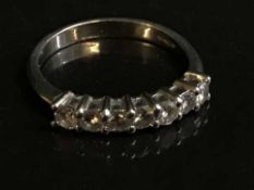 A platinum diamond half eternity ring