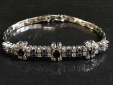 A sapphire and diamond bracelet set in white gold, diamond weight estimated at 1 carat, 23.
