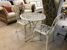 A cast painted garden table and three chairs