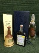 A box of Bells whiskey decanter, bottle of gin,