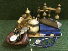 A tray of two cast metal boot scrapers, doctor's stethoscope, brass tea set,