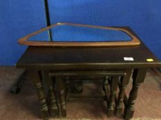 An oak nest of three tables and a wall mirror