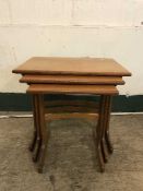 A nest of three teak tables