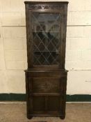 A Jaycee oak and leaded glass corner cabinet