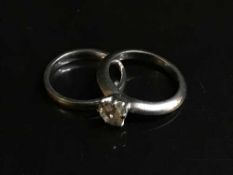 A platinum and diamond solitaire ring, 0.