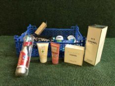 A basket of assorted body sprays, cosmetics,