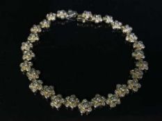 An 18ct gold floral diamond bracelet, 17.6g, approximately 3ct.