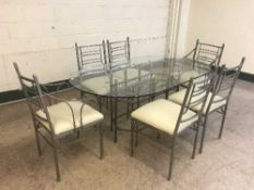 A contemporary metal and glass topped dining table with six chairs