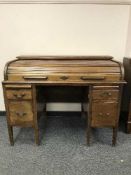 An early 20th century mahogany roll top desk,