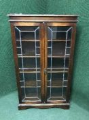 An oak leaded glass bookcase