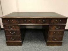 A Georgian style mahogany pedestal desk with tooled green leather top,