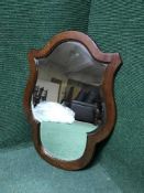 A shaped mahogany wall mirror