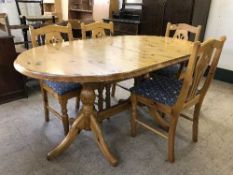 A pine dining table and four chairs