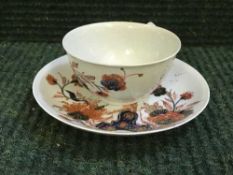 An eighteenth century English china teabowl and saucer, probably Lowestoft,