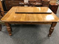 A late Victorian oak extending dining table with two leaves, length fully extended 238.