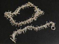 A silver necklace and bracelet set
