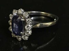 An 18ct white gold diamond sapphire cluster ring
