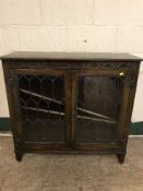 A Jaycee carved oak display cabinet